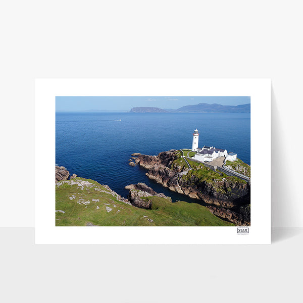 Unframed aerial photograph of Fanad Lighthouse in Donegal on a clear day with blue sky and rugged coastline