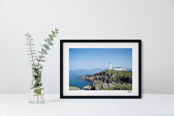 Fanad Lighthouse photograph in a black frame showing Donegal coastline under a clear blue sky