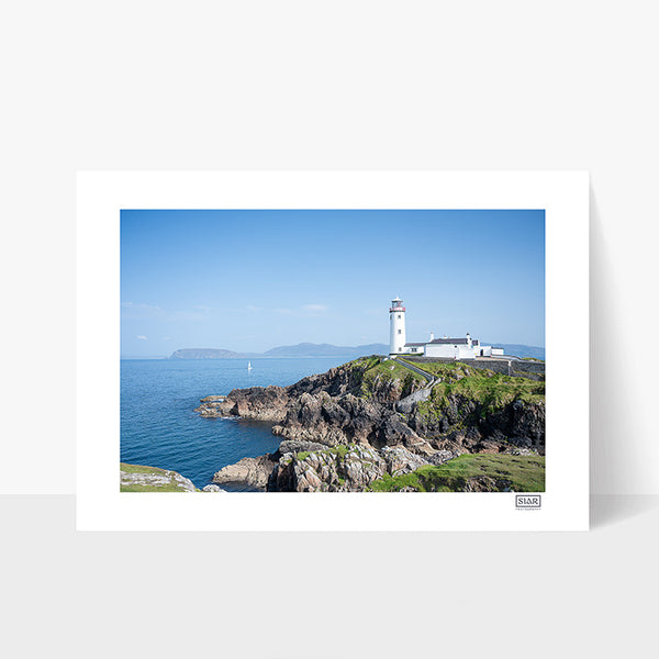 Unframed photograph of Fanad Lighthouse in Donegal on a clear blue-sky day with rugged coastline