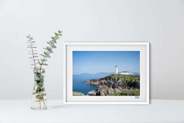 Fanad Lighthouse photograph in a white frame showing Donegal coastline under a clear blue sky