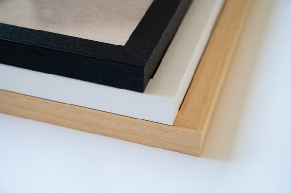 Three frame color options: white, black, and natural wood, handmade in Ireland