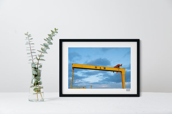 Harland & Wolff cranes photo in a black frame showing Belfast skyline with blue and pink sky