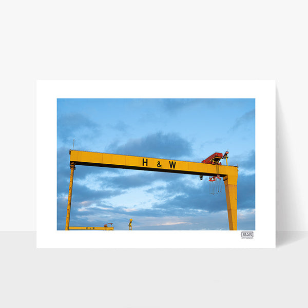Unframed print of Harland & Wolff cranes in Belfast against blue and pink sky