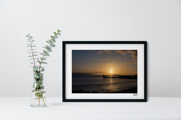 A black framed sunset photograph of The Blackrock Diving Tower at Salthill Beach Galway