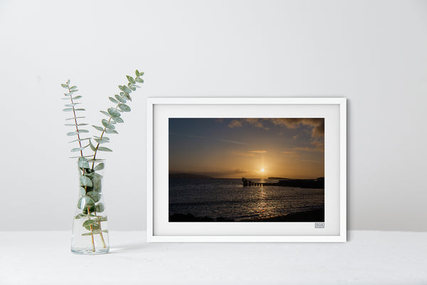 A contemporary white framed sunset photograph of The Blackrock Diving Tower at Salthill Beach Galway